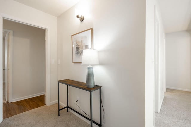 hallway featuring light carpet