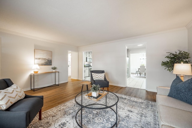 living room with hardwood / wood-style floors and ornamental molding