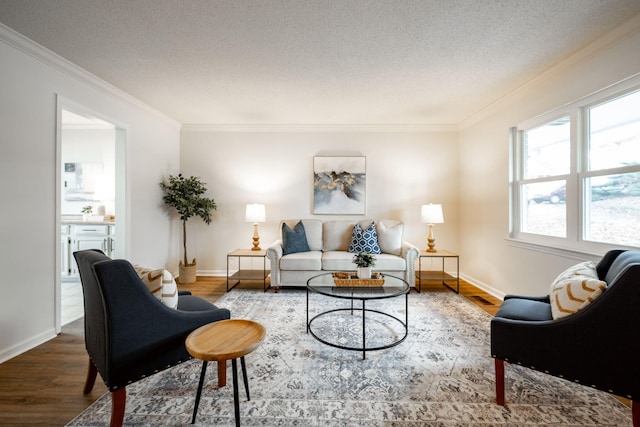 living room featuring hardwood / wood-style flooring, ornamental molding, and a textured ceiling