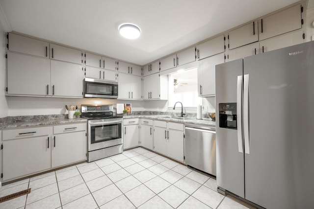 9100 Coventry Ln, Chattanooga, TN 37416 - kitchen featuring appliances with stainless steel finishes, a sink, light countertops, and light tile patterned floors