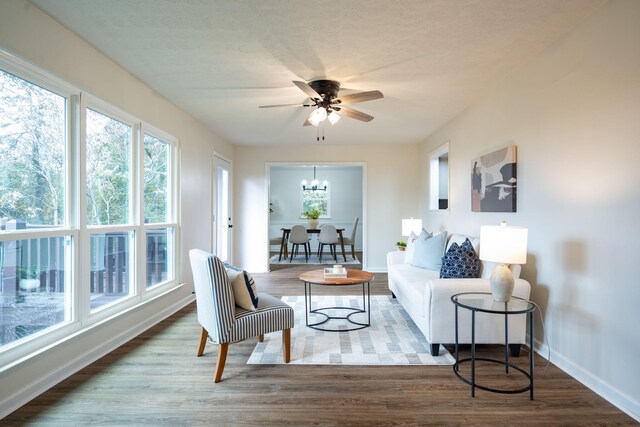 9100 Coventry Ln, Chattanooga, TN 37416 - living area with baseboards, a chandelier, wood finished floors, and a ceiling fan