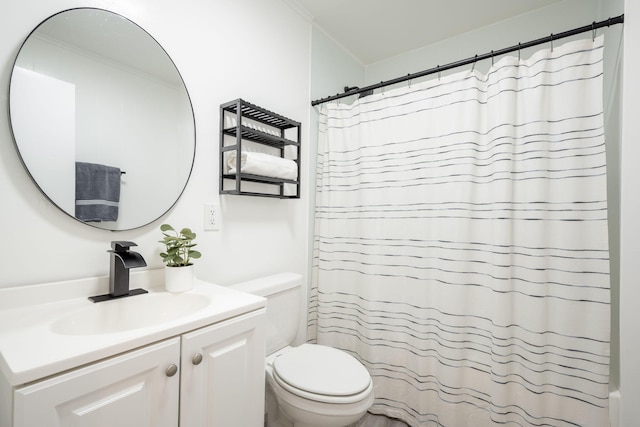 bathroom with a shower with curtain, vanity, toilet, and crown molding