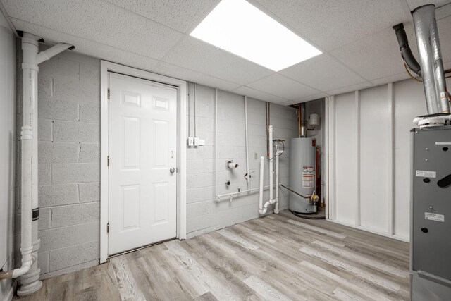 9100 Coventry Ln, Chattanooga, TN 37416 - finished below grade area featuring gas water heater, a paneled ceiling, concrete block wall, and light wood-type flooring