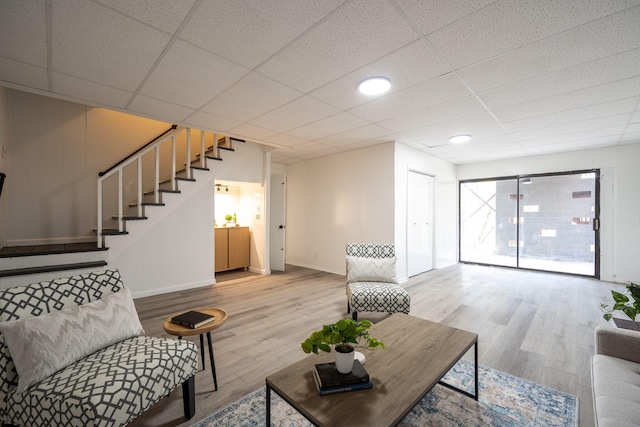 9100 Coventry Ln, Chattanooga, TN 37416 - living area featuring wood finished floors, stairs, baseboards, and a drop ceiling