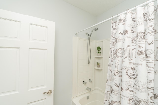 bathroom featuring shower / bathtub combination with curtain and a textured ceiling