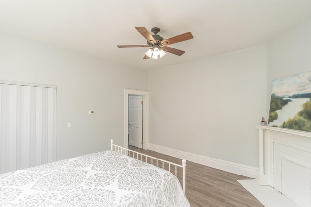 bedroom featuring wood finished floors, baseboards, and ceiling fan