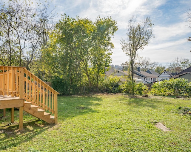 view of yard with a wooden deck and stairway