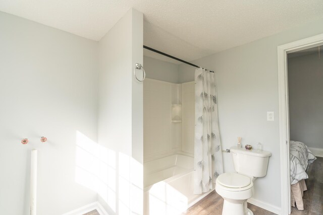 bathroom featuring toilet, shower / bathtub combination with curtain, wood finished floors, and baseboards