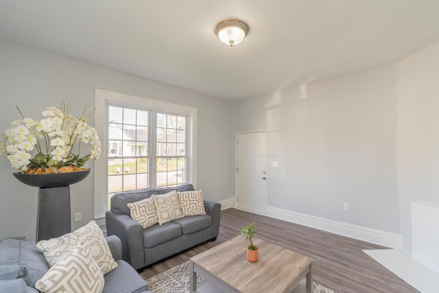 living room with dark wood-style flooring and baseboards