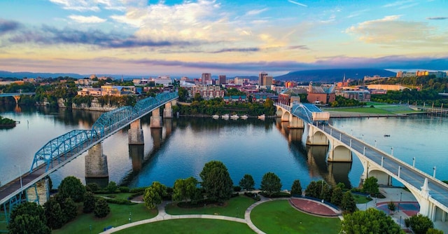 view of urban area with a notable bridge and a nearby body of water