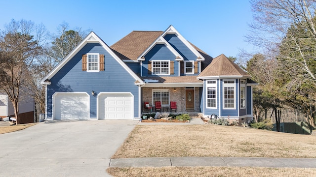 view of front of house with a front lawn, covered porch, and a garage