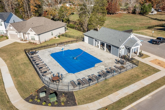 view of swimming pool with a lawn