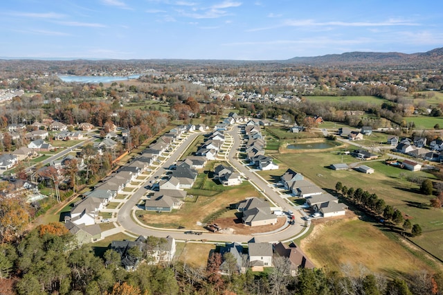 drone / aerial view featuring a water and mountain view