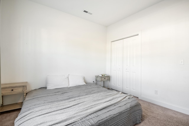 bedroom featuring dark colored carpet and a closet