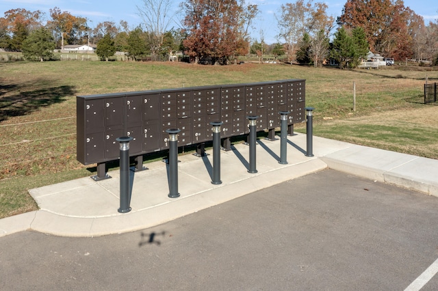 view of community with a yard and a mail area