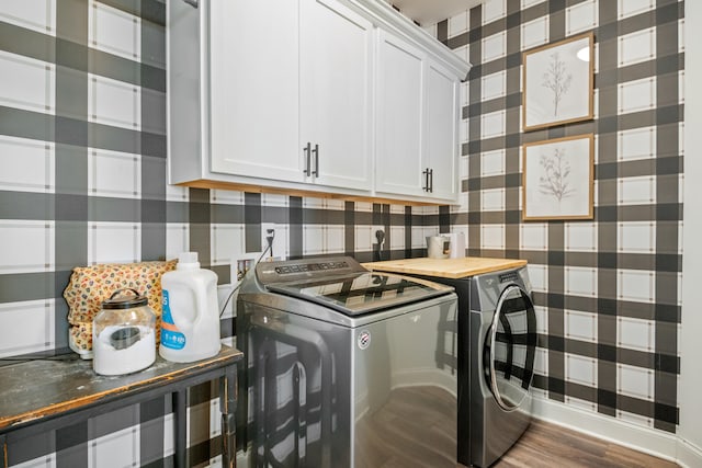 clothes washing area with hardwood / wood-style floors, cabinets, and independent washer and dryer