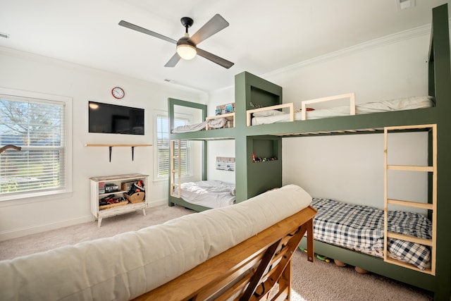 carpeted bedroom featuring ceiling fan and crown molding