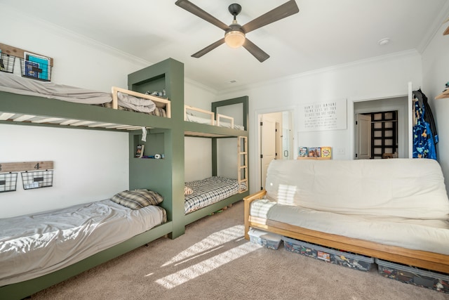 bedroom with ceiling fan, crown molding, and carpet