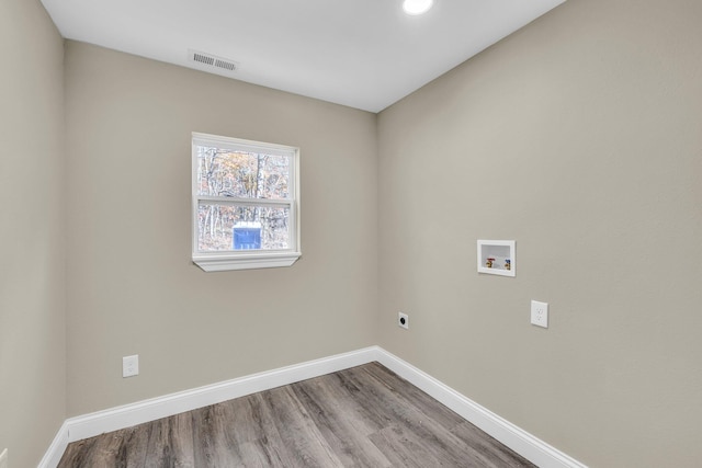 washroom with hookup for a washing machine, electric dryer hookup, and hardwood / wood-style floors