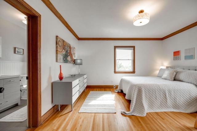 bedroom featuring connected bathroom, crown molding, and light hardwood / wood-style floors