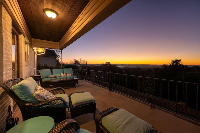 patio terrace at dusk featuring an outdoor living space