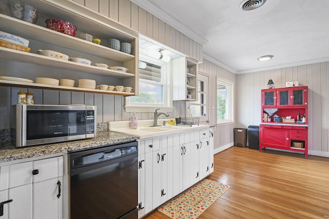 kitchen with ornamental molding, sink, light hardwood / wood-style flooring, black dishwasher, and white cabinetry