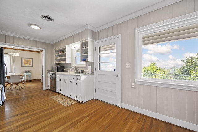 kitchen featuring white cabinetry, crown molding, stainless steel appliances, and wood-type flooring