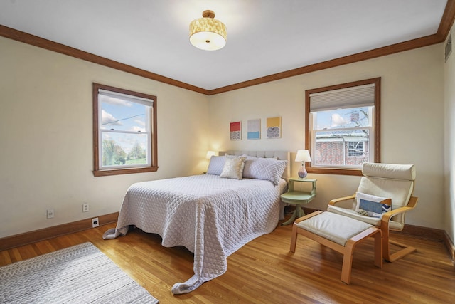 bedroom with light hardwood / wood-style flooring and ornamental molding