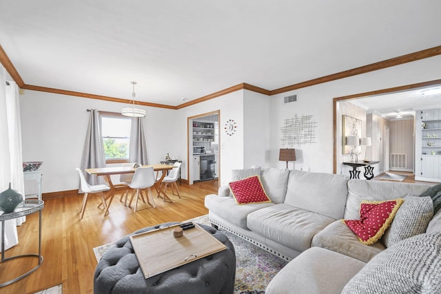 living room featuring light hardwood / wood-style flooring and crown molding