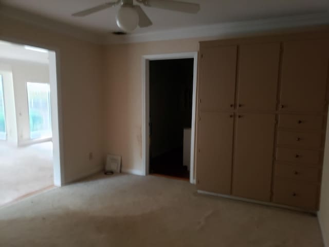 unfurnished bedroom featuring ceiling fan and light colored carpet