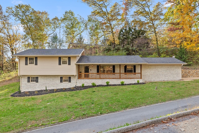 split level home featuring a porch and a front lawn