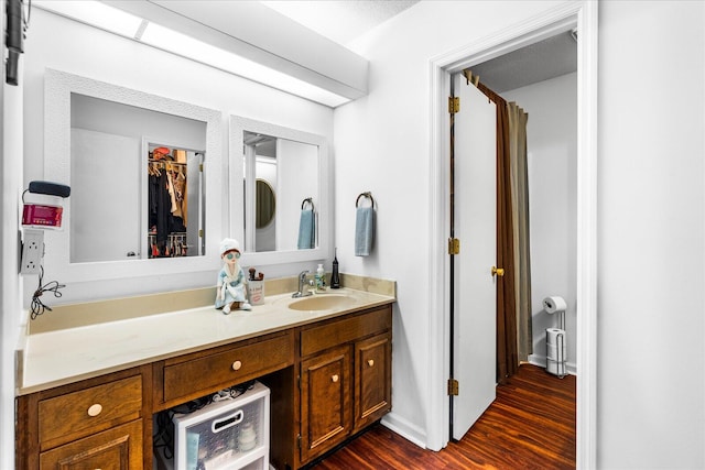 bathroom featuring a textured ceiling, vanity, and hardwood / wood-style flooring