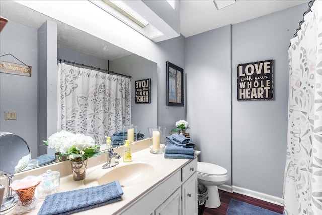 bathroom featuring hardwood / wood-style floors, vanity, and toilet