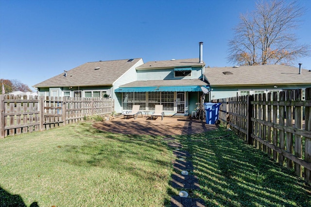 back of property with a lawn and a patio area