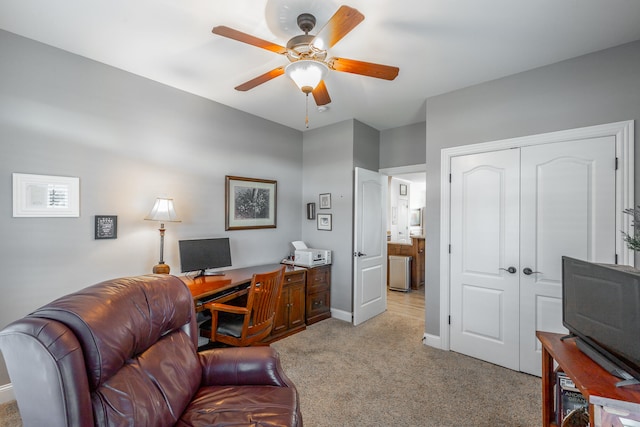 carpeted office featuring ceiling fan