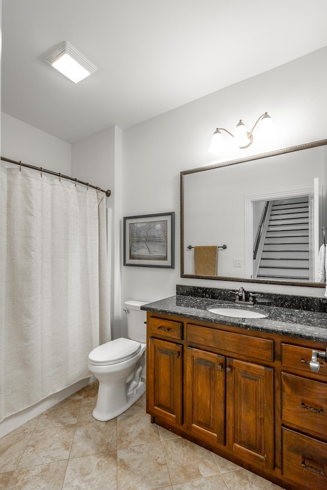 bathroom featuring tile patterned flooring, vanity, and toilet