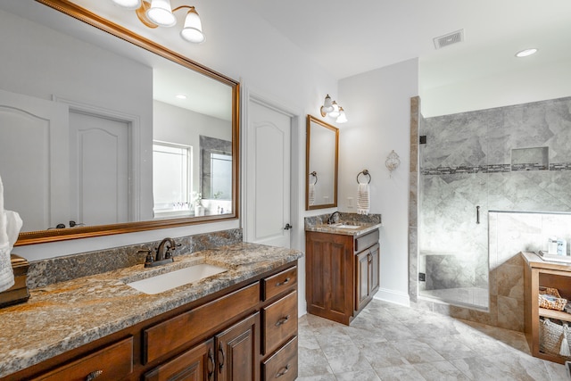 bathroom featuring a tile shower and vanity