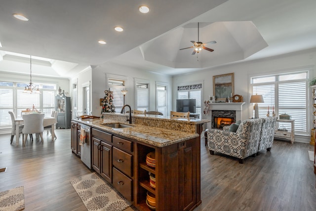 kitchen featuring a center island with sink, hanging light fixtures, a healthy amount of sunlight, and sink