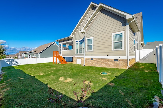 rear view of house with a yard