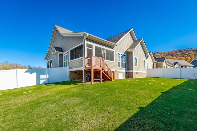 back of property featuring a sunroom and a yard