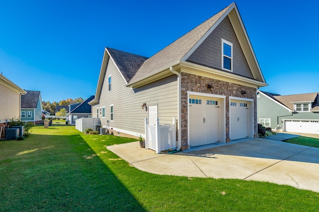 view of property exterior with a lawn, central AC unit, and a garage