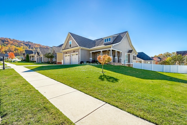 view of front of house featuring a front lawn, a porch, and a garage