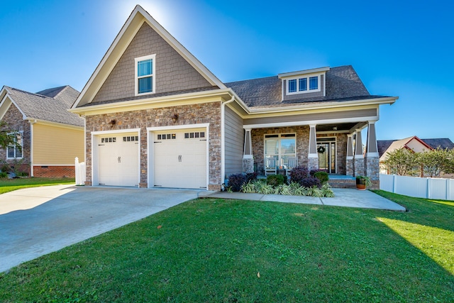 craftsman inspired home with a garage, a porch, and a front yard