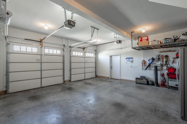 garage with stainless steel refrigerator and a garage door opener