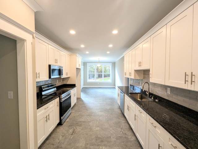 kitchen with white cabinetry, appliances with stainless steel finishes, and sink