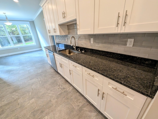 kitchen featuring sink, dishwasher, hanging light fixtures, ornamental molding, and white cabinets