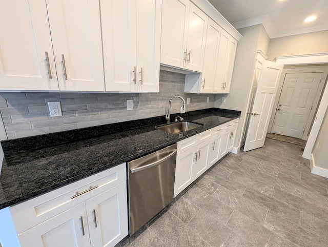 kitchen with sink, white cabinets, decorative backsplash, dark stone counters, and stainless steel dishwasher