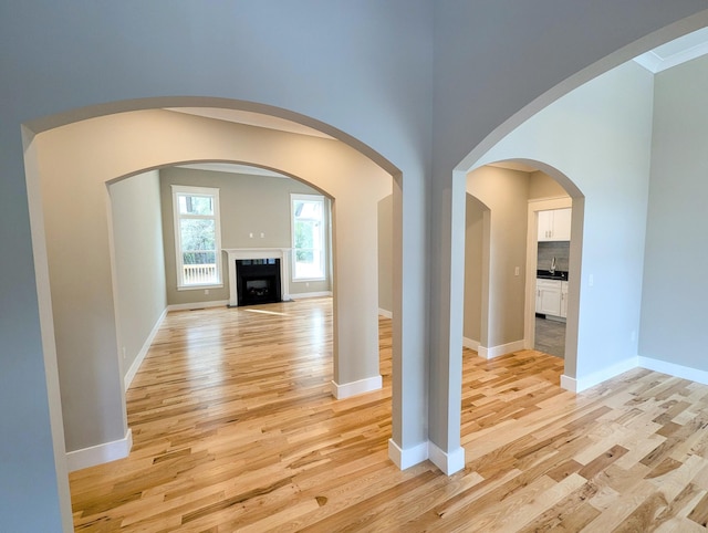 corridor with light hardwood / wood-style floors