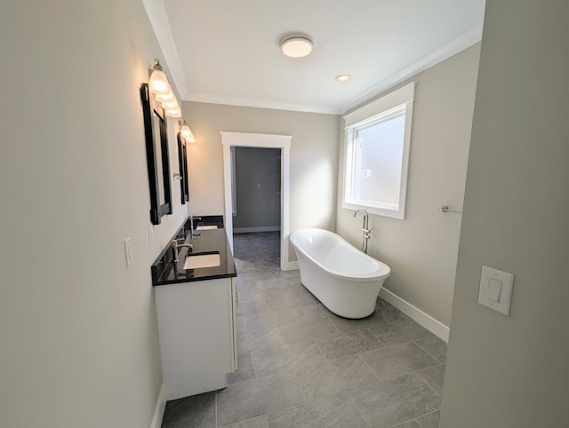 bathroom with vanity, a tub to relax in, and ornamental molding