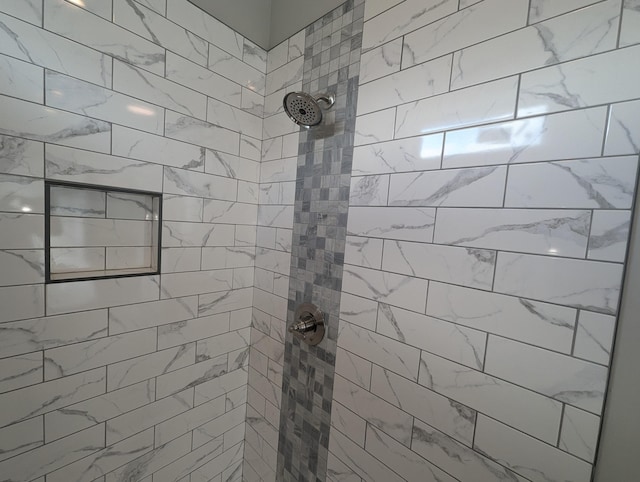 bathroom with tiled shower